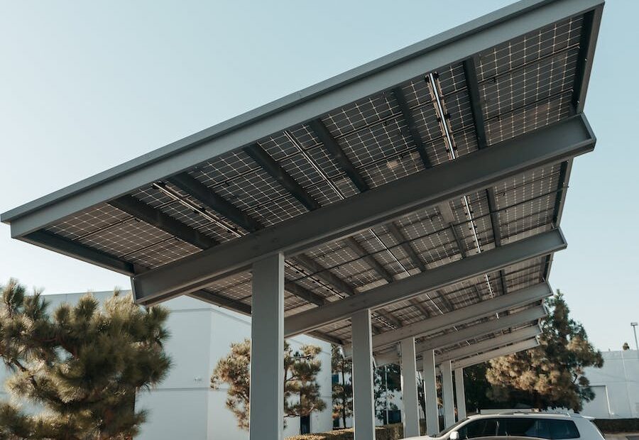 Cars Parked on Parking Lot Under the Solar Panels